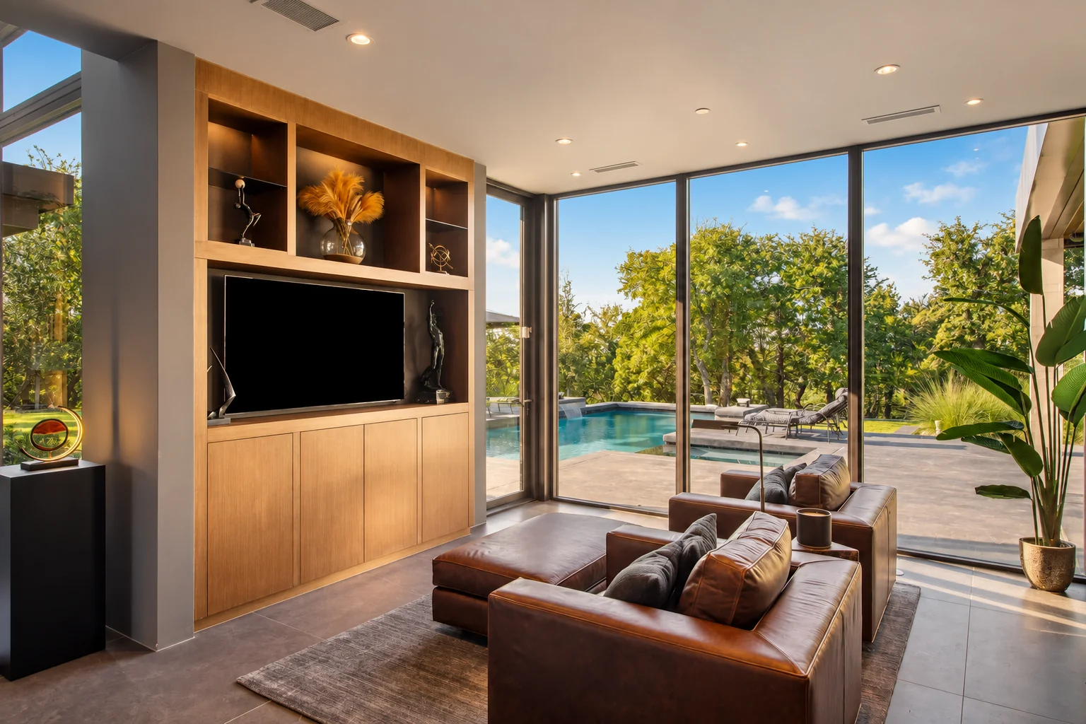 Living room opening onto a terrace and pool; illustrative residential setting